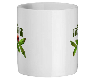 White mug with green text and graphics on a white background