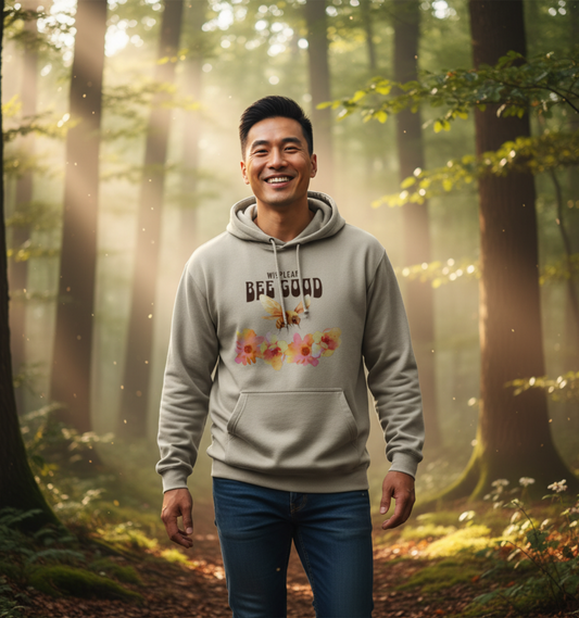 Man wearing a hoodie with floral design and text in a forest