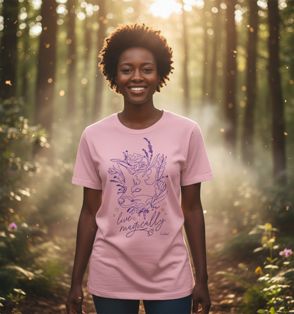 Woman wearing a pink t-shirt with a floral design and text in a forest setting